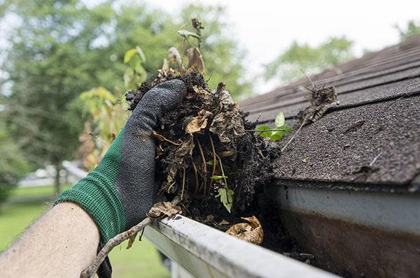 installing gutter guards can help prevent debris from building up in your gutters after cleaning